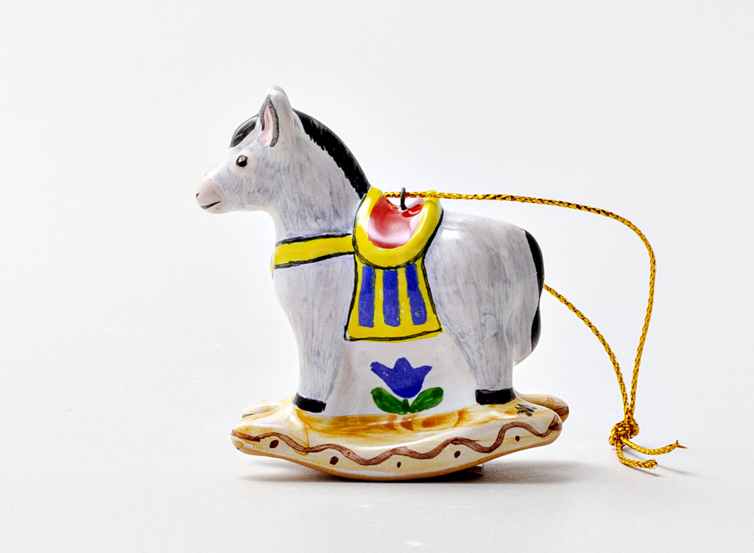 Елочная игрушка «Ослик-качалка 1» Форма: Ослик-качалка 1. Майолика. 57 x 22 x 57 мм.